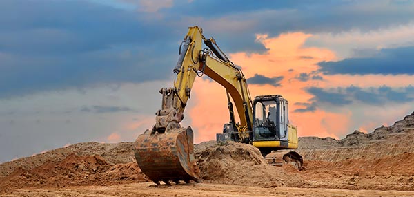 Heavy equipment working an abrasive open-pit site